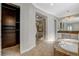 Bathroom featuring glass-enclosed shower, soaking tub, and access to walk-in closet at 2172 De Rouge Ave, Henderson, NV 89044