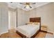 Bedroom with hardwood floors, light colored walls, and view to attached bath at 2172 De Rouge Ave, Henderson, NV 89044
