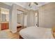 Bedroom with hardwood floors and mirrored closet doors reflecting a bathroom vanity at 2172 De Rouge Ave, Henderson, NV 89044