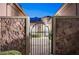 Inviting entryway framed by stone pillars and a wrought-iron gate, ensuring privacy and curb appeal at 2172 De Rouge Ave, Henderson, NV 89044