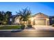Charming single-story home with a well-manicured lawn and a two-car garage at twilight at 2172 De Rouge Ave, Henderson, NV 89044