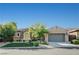Charming home exterior with stone accents, well-manicured lawn, and a two-car garage at 2172 De Rouge Ave, Henderson, NV 89044