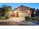 Charming home featuring a three car garage, desert landscaping, and inviting curb appeal at 2172 De Rouge Ave, Henderson, NV 89044