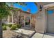Charming home featuring a stone accented entry way with wrought iron gate and desert landscaping at 2172 De Rouge Ave, Henderson, NV 89044