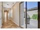 Hallway with tile flooring leading to a patio view with outdoor furniture at 2172 De Rouge Ave, Henderson, NV 89044