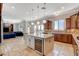 Open kitchen featuring an island with wine cooler, granite countertops, and stainless steel appliances at 2172 De Rouge Ave, Henderson, NV 89044
