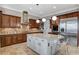 Kitchen boasts granite countertops, stainless appliances, custom cabinetry and an island with seating at 2172 De Rouge Ave, Henderson, NV 89044