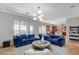 Bright living room with plush blue seating, modern lighting, and an open floor plan at 2172 De Rouge Ave, Henderson, NV 89044
