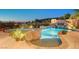 Beautiful pool with rock waterfall feature, lush landscaping, and inviting spa at 2172 De Rouge Ave, Henderson, NV 89044