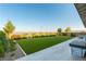 Spacious backyard features a manicured lawn, patio, and privacy fence for outdoor enjoyment at 218 Vista Balla Ave, Las Vegas, NV 89138