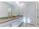 Bathroom with double sinks, white cabinets, and quartz countertop, reflecting the bath tub at 218 Vista Balla Ave, Las Vegas, NV 89138