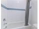 Clean bathroom featuring a shower-tub combo, white tile, and a gray shower curtain at 218 Vista Balla Ave, Las Vegas, NV 89138