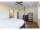Bright bedroom with hardwood floors, featuring a four-poster bed and ensuite bathroom access at 218 Vista Balla Ave, Las Vegas, NV 89138