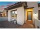 Inviting entrance with outdoor seating, a stylish front door, and brick-paved patio at 218 Vista Balla Ave, Las Vegas, NV 89138