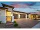 Stylish home features a brick driveway, two-car garage, and landscaped yard at 218 Vista Balla Ave, Las Vegas, NV 89138