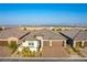 Charming single-story home featuring a brick driveway, lush landscaping, and a welcoming front porch, bathed in natural light at 218 Vista Balla Ave, Las Vegas, NV 89138