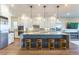 Modern kitchen featuring a large center island, pendant lighting, stainless steel appliances and white cabinetry at 218 Vista Balla Ave, Las Vegas, NV 89138