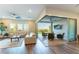Stylish living room with hardwood floors, comfortable sofas, and sliding glass doors to the outdoor patio at 218 Vista Balla Ave, Las Vegas, NV 89138