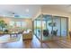 Bright living room featuring hardwood floors, modern furnishings, and large windows with an indoor outdoor feel at 218 Vista Balla Ave, Las Vegas, NV 89138