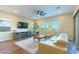 Comfortable living room featuring hardwood floors, a modern entertainment center, and sliding glass doors at 218 Vista Balla Ave, Las Vegas, NV 89138