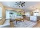 Spacious living room featuring a comfortable sofa, stylish rug, and modern ceiling fan at 218 Vista Balla Ave, Las Vegas, NV 89138