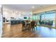 Open-concept living space with modern kitchen, dining area, and access to an outdoor patio at 218 Vista Balla Ave, Las Vegas, NV 89138