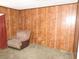 Bedroom featuring wood paneling, neutral carpet and simple furnishings at 2813 Willoughby Ave, Las Vegas, NV 89101