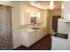 Galley kitchen with white cabinets, laminate countertops and dark floors at 2813 Willoughby Ave, Las Vegas, NV 89101