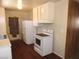 Galley kitchen with white cabinets, laminate countertops and dark floors at 2813 Willoughby Ave, Las Vegas, NV 89101