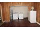 Laundry room with wood paneling, washer, dryer and extra refrigerator at 2813 Willoughby Ave, Las Vegas, NV 89101
