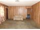Living room featuring wood paneling, neutral carpet and simple furnishings at 2813 Willoughby Ave, Las Vegas, NV 89101