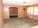 Cozy living room featuring wood paneled walls, soft natural light, and carpeted floors at 2813 Willoughby Ave, Las Vegas, NV 89101