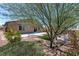 Open backyard featuring landscaping with a patio and stone accents surrounding the grass at 3012 Chiefs Ct, North Las Vegas, NV 89032