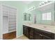 Bathroom with double sink vanity, large mirror, and walk-in closet at 3012 Chiefs Ct, North Las Vegas, NV 89032
