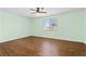 Light-filled bedroom with wood floors and a ceiling fan at 3012 Chiefs Ct, North Las Vegas, NV 89032