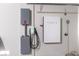 Garage featuring a Tesla power wall, electrical panel, and Tesla wall charging unit at 3012 Chiefs Ct, North Las Vegas, NV 89032