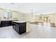 Open concept living area featuring an island kitchen, tile flooring, and adjacent sitting area at 3012 Chiefs Ct, North Las Vegas, NV 89032