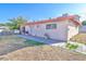 The backyard has a small patio and drought tolerant landscaping at 304 Perkins Cir, Las Vegas, NV 89106