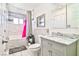 Renovated bathroom features tiled walls, gray vanity, a toilet and a tub/shower combo at 304 Perkins Cir, Las Vegas, NV 89106