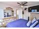 Bedroom featuring wood-look floors, ceiling fan, television and dresser with mirror at 304 Perkins Cir, Las Vegas, NV 89106
