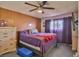 Bedroom featuring wood paneling, a ceiling fan, and a purple bedspread at 304 Perkins Cir, Las Vegas, NV 89106