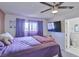 Bedroom featuring a ceiling fan, a TV, and an open doorway to the bathroom at 304 Perkins Cir, Las Vegas, NV 89106