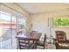 Bright dining area with sliding doors leading to the backyard and a comfortable recliner nearby at 304 Perkins Cir, Las Vegas, NV 89106