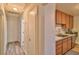 Bright hallway featuring wood-look floors, a built-in linen closet, and entry into the kitchen at 304 Perkins Cir, Las Vegas, NV 89106