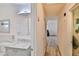 Hallway featuring wood-look floors and leading into a bathroom and living area at 304 Perkins Cir, Las Vegas, NV 89106