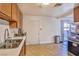 Spacious kitchen with wooden cabinets, stainless steel sink, and sliding door access to the outdoor area at 304 Perkins Cir, Las Vegas, NV 89106