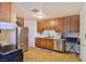 Functional kitchen features stainless steel appliances, wooden cabinets, and ample countertop space for meal preparation at 304 Perkins Cir, Las Vegas, NV 89106
