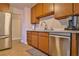 Kitchen features a stainless steel refrigerator and appliances, alongside wooden cabinets and light countertops at 304 Perkins Cir, Las Vegas, NV 89106