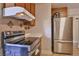 Updated kitchen featuring modern appliances, tile backsplash, and efficient layout for cooking at 304 Perkins Cir, Las Vegas, NV 89106