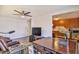Cozy living room featuring a ceiling fan, modern flooring, and a glimpse into the adjacent kitchen at 304 Perkins Cir, Las Vegas, NV 89106